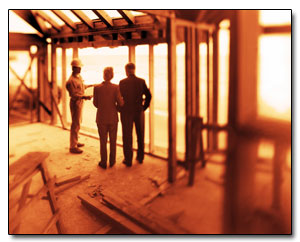 ist2_7828848-couple-talking-to-construction-worker-in-framework-of-house